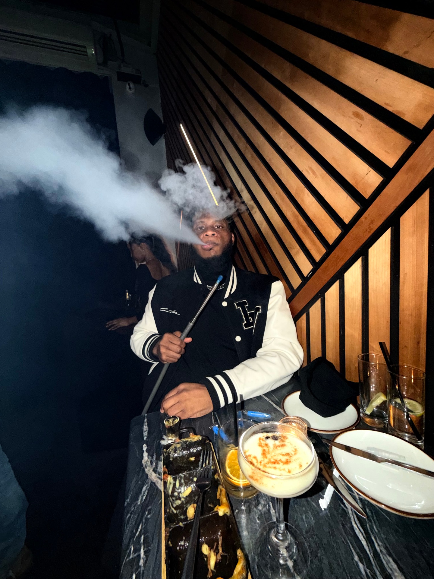 Anthony, founder and owner of Heroes Hookah, enjoying a session at the lounge