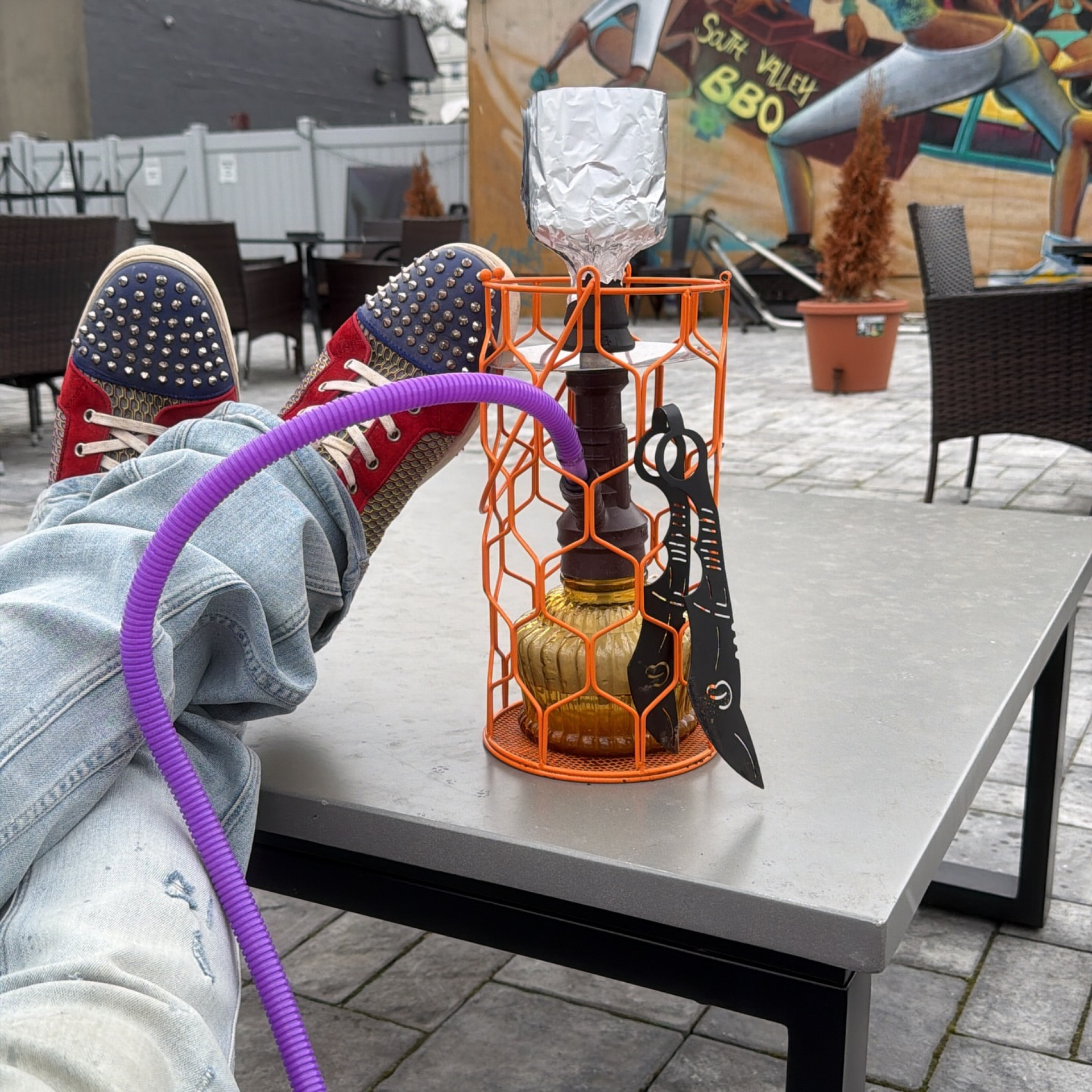 Close-up of Heroes Hookah signature orange caged hookah on the lounge patio